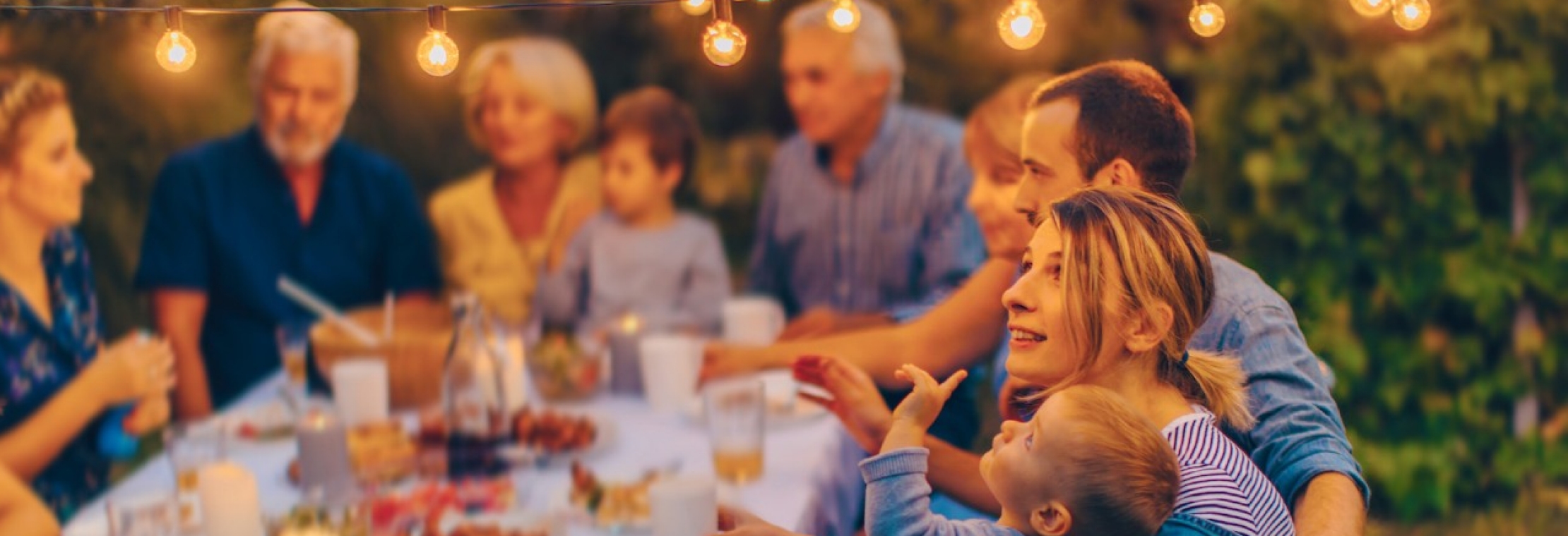 mom and son at a family table pointing at a bulb