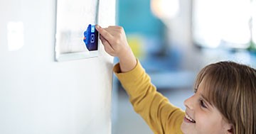 child pressing buttons on a tablet